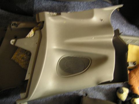 1993 Ford Probe - This is a tan interior trim panel with a speaker grille, likely a replacement part.