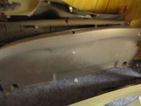 1993 Ford Probe - A close-up view of a dark-colored plastic automotive interior trim piece.