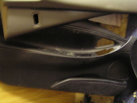 1993 Ford Probe - Close-up of a car's interior door panel, showing a speaker and a storage pocket.