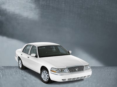 2003 Mercury Marquis - A white 2003 Mercury Marquis is shown from the front three-quarter angle against a gray background.