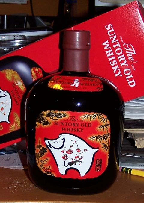 1990 Ford Bronco - A bottle of Suntory Old Whisky, a pig motif, sits beside its red packaging.