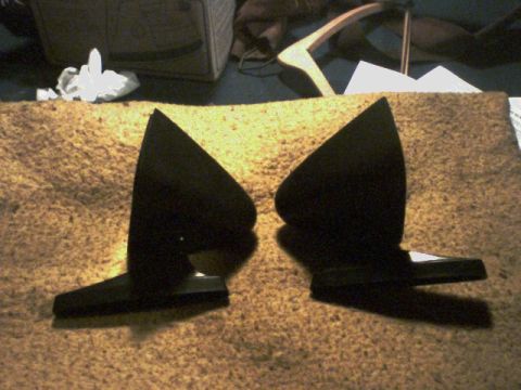 1973 Ford Ranchero - A pair of black side mirrors are laid out on a textured surface, with some background items visible.