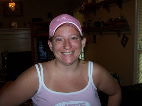 1979 Ford F-150 - A woman smiles while wearing a pink baseball cap and a pink tank top.