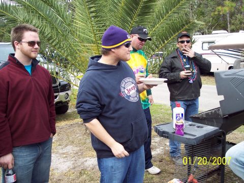 1984 Toyota 4Runner - A black SUV is partially visible behind a group of men at an outdoor gathering.
