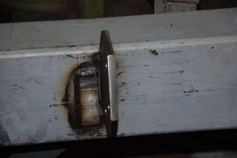 1996 Ford Bronco - Close-up view of a metal bracket welded onto a vehicle frame, likely part of a rear bumper modification.