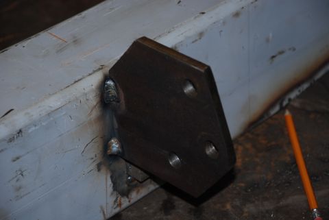 1996 Ford Bronco - Custom metal bracket welded onto a frame, with a pencil nearby.