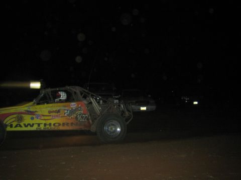 1990 Ford Bronco - yellow open-frame off-road race buggy marked Hawthorne de Mexico and number 1622 sits on a dark dirt course.