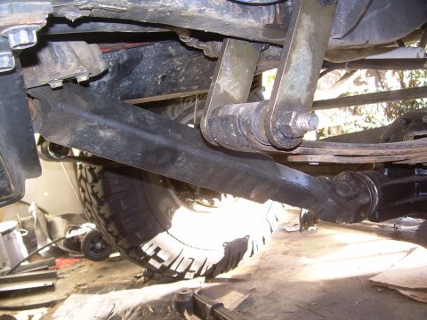 1993 Toyota 4Runner - A close-up view of the undercarriage and suspension components of a vehicle, with a large tire visible.