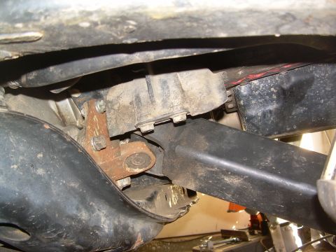 1993 Toyota 4Runner - Close-up of a rusty bracket and associated components on a vehicle's undercarriage.
