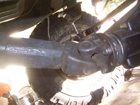 1993 Toyota 4Runner - Close-up of the driveshaft and differential assembly, showing mechanical components and a tire.
