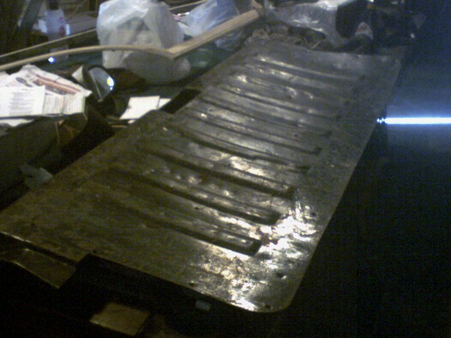 Corrugated metal panel, possibly a truck bed liner or undercarriage part