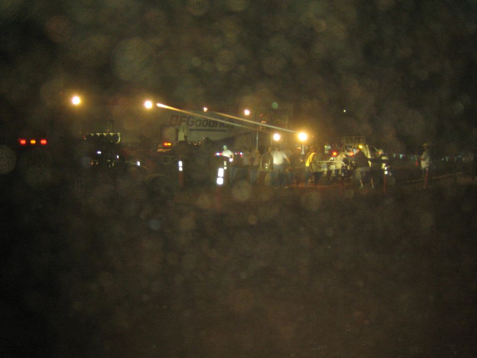 Nighttime off-road race pit area with BFGoodrich banner and crowd