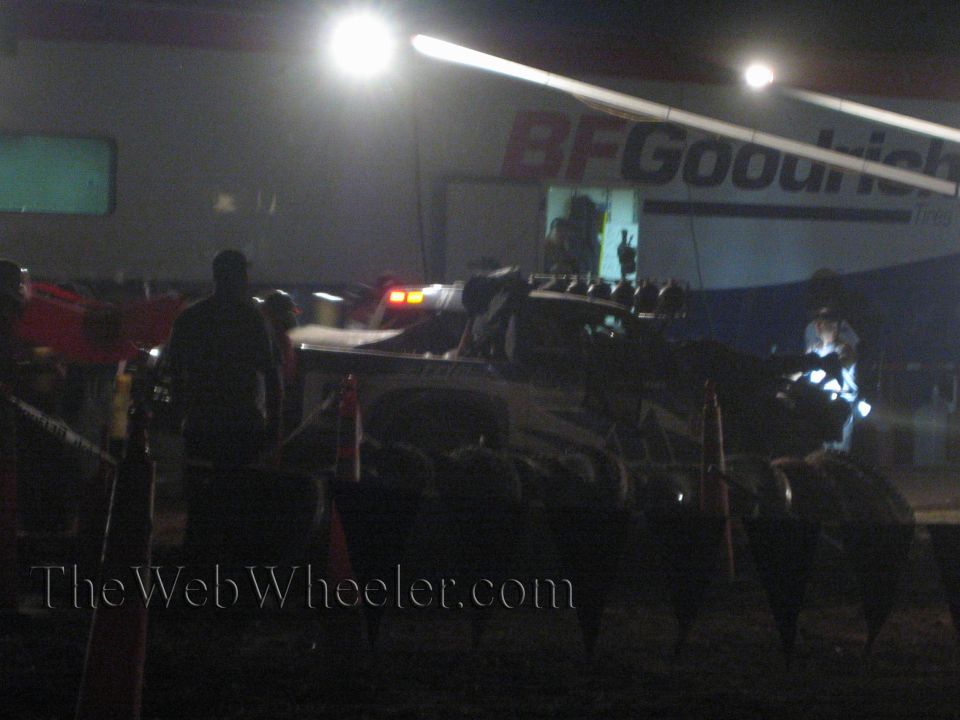 Off-road race truck in pit at night under BFGoodrich banner and floodlights