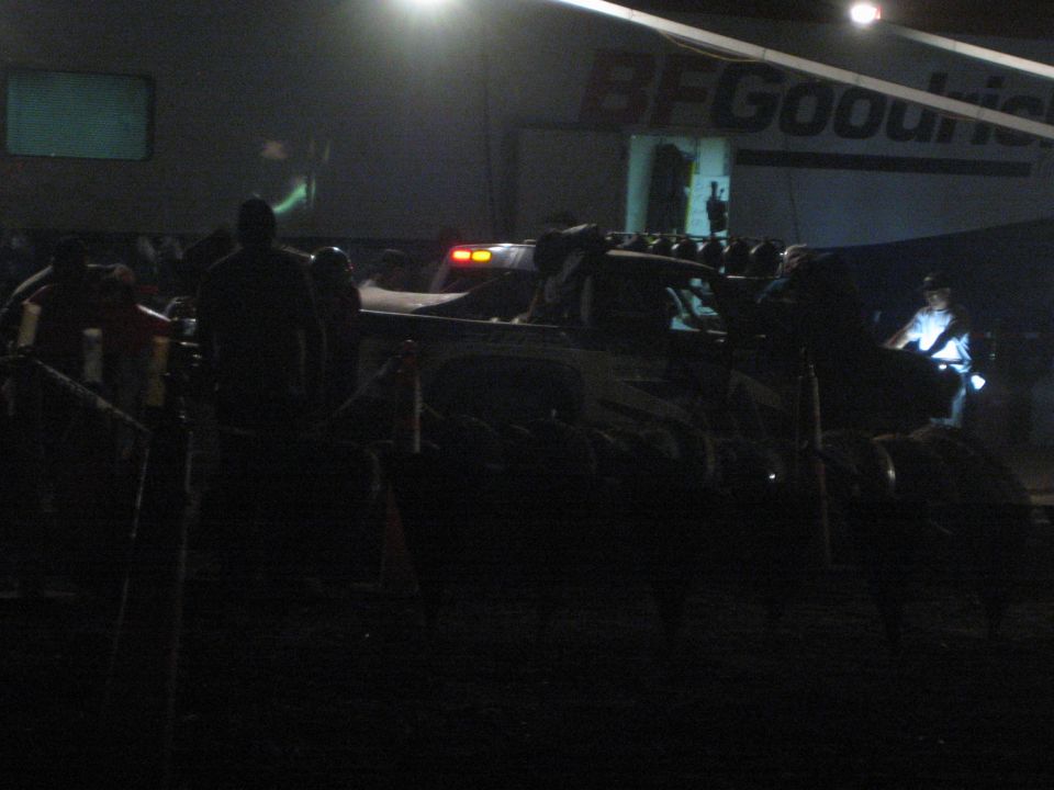 Off-road race truck in dark pit at night under BFGoodrich banner