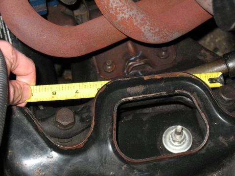 1985 Ford Crown Victoria LTD - A tape measure is used to check the clearance of an engine component.