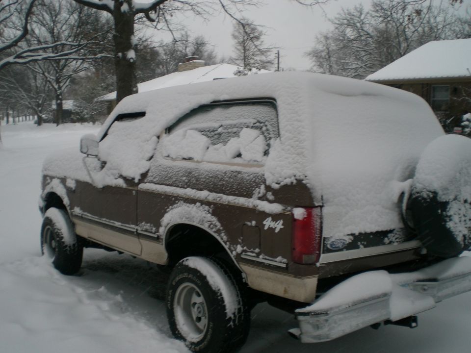 1992 Ford Bronco in snow, rear 3/4 view