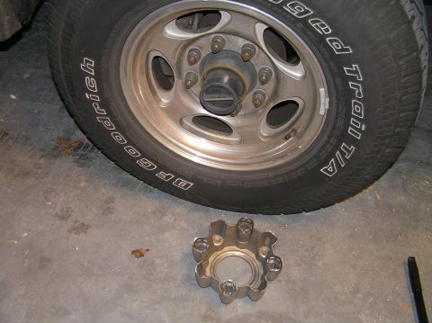 2000 Ford Excursion - A tire and a removed wheel hub are shown on a concrete floor.
