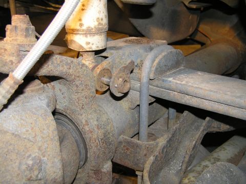 2000 Ford Excursion - With the wheel removed, we can now remove the lower shock bolt. We need to disconnect the shock so we don't over-extend it when we drop the…