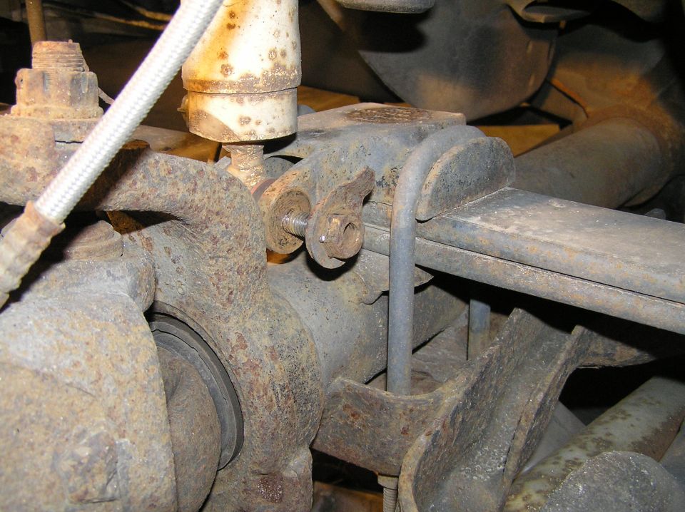 With the wheel removed, we can now remove the lower shock bolt. We need to disconnect the shock so we don't over-extend it when we drop the front axle in a later step.

[b]Tools Needed:[/b]
You'll want air tools. This bolt will probably be very rusty.
21mm socket (for bolt)
15mm socket (for nut)