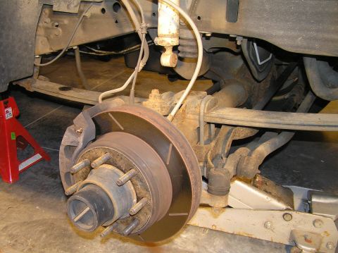 2000 Ford Excursion - With the lower shock bolt removed, you can compress the shock as much as possible to get it out of your way for the rest of the project. Yo…