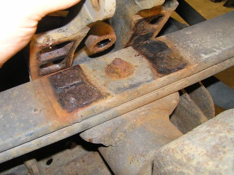 2000 Ford Excursion - Lift the bump-stop off of the leaf spring.