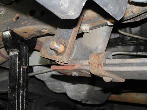 2000 Ford Excursion - Next up, remove the nut from the rear eye-bolt of the leaf spring. Simply punch the bolt through the hole with a hammer. Make sure not to c…