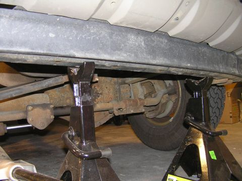 2000 Ford Excursion - Position 2 jack stands under the blocker beam so it doesn't crash to the ground when you unbolt it. Tools Needed: (2) jack stands