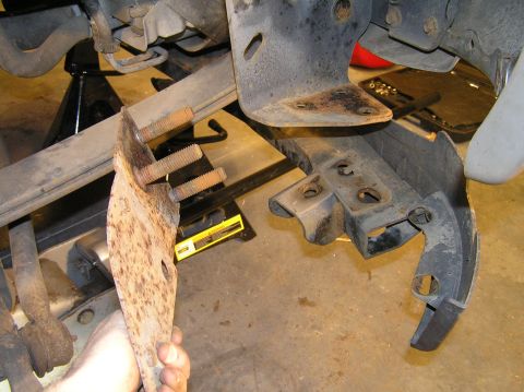 2000 Ford Excursion - Lift the blocker beam bracket out of the holes in the blocker beam.