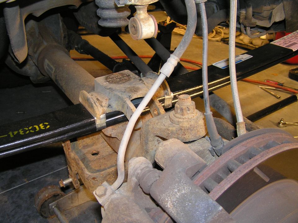 Reinstall the bump-stop/u-bolt plate. The notch in the bump-stop lines up with the nut on top of the leaf spring.