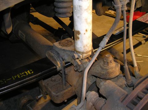 2000 Ford Excursion - Re-attach shock with lower shock bolt. Tools Needed: 21mm socket (for bolt) 15mm socket (for nut) 1/2" ratchet 1/2" impact wrench
