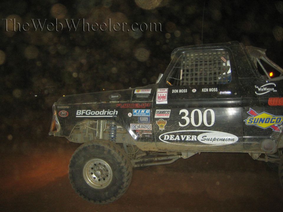 Black number 300 off-road race truck racing at night