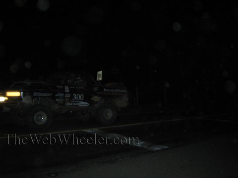 Off-road race truck number 300 at night with headlights and BFGoodrich graphics