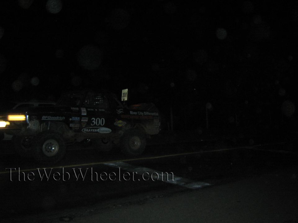 Off-road race truck number 300 at night with headlights and BFGoodrich graphics