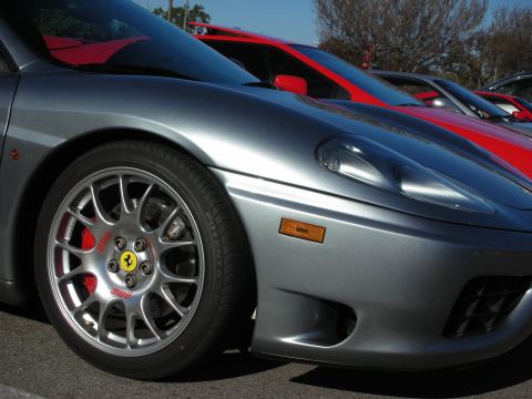 1998 Ford Crown Victoria - Front quarter of a silver Ferrari 360 showing a multi-spoke wheel, red prancing-horse caliper and side intake.