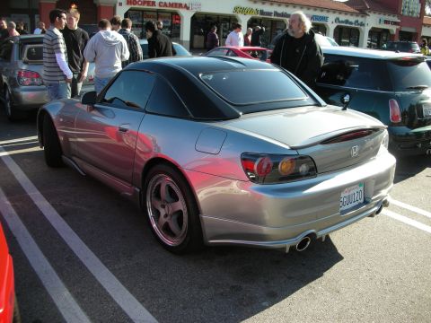 1998 Ford Crown Victoria - Rear three-quarter of a silver Honda S2000 roadster with hardtop and aftermarket wheels at a strip-mall car meet.