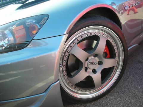 1998 Ford Crown Victoria - Close-up of a silver Honda S2000's deep-dish wheel with red caliper, taillight and S2000 fender badge visible.