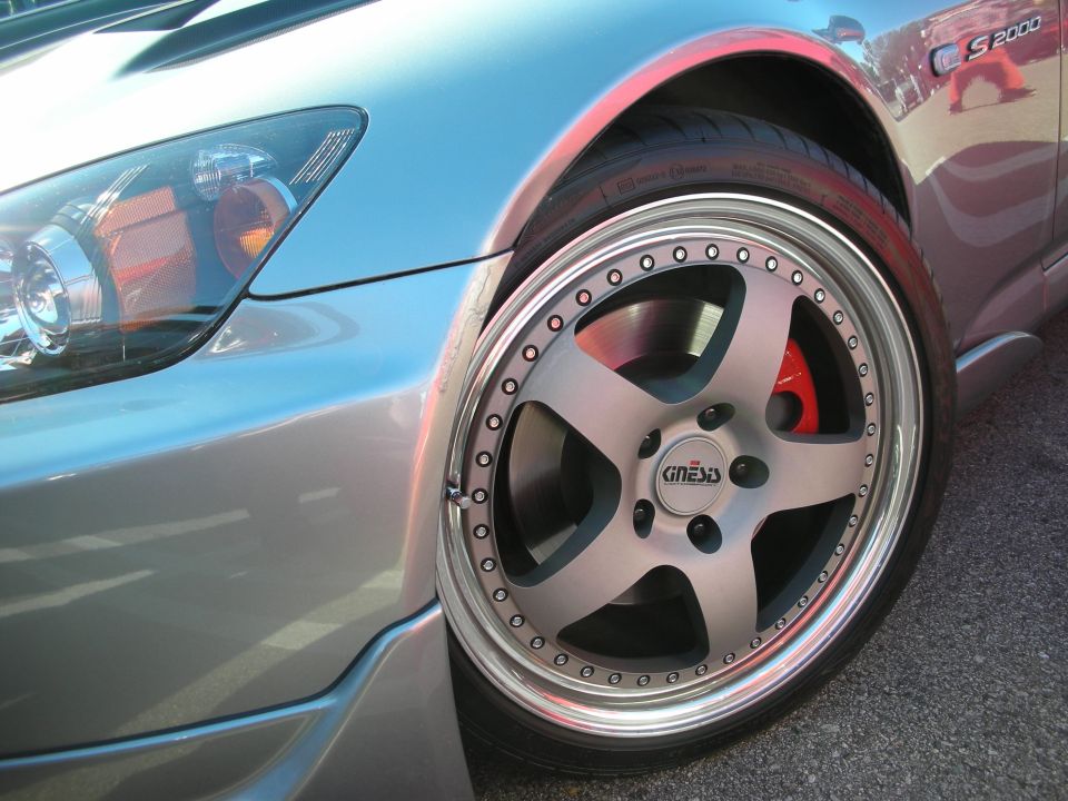 Silver Honda S2000 front wheel close-up with red caliper and S2000 badge