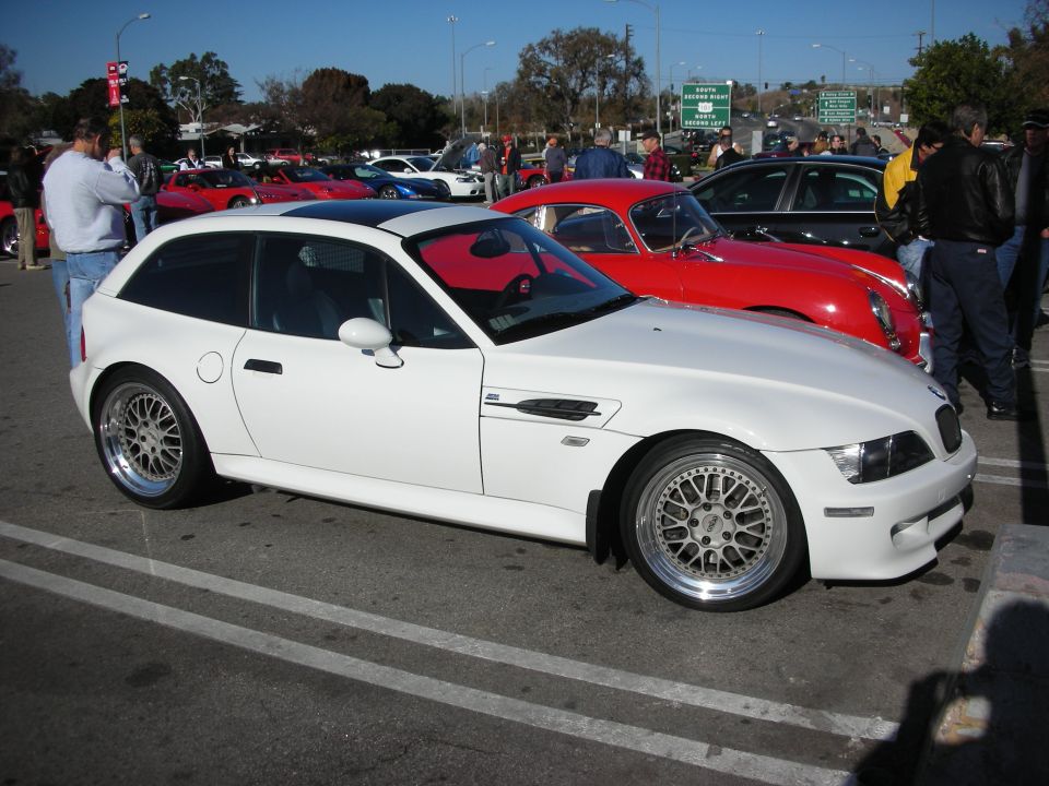 White BMW Z3 M Coupe with polished multi-spoke wheels at a car show