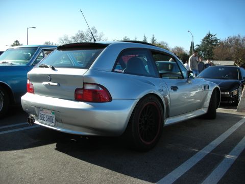 1998 Ford Crown Victoria - silver BMW Z3 coupe parked outdoors with black wheels and a personalized California plate reading ZEE SHOE.