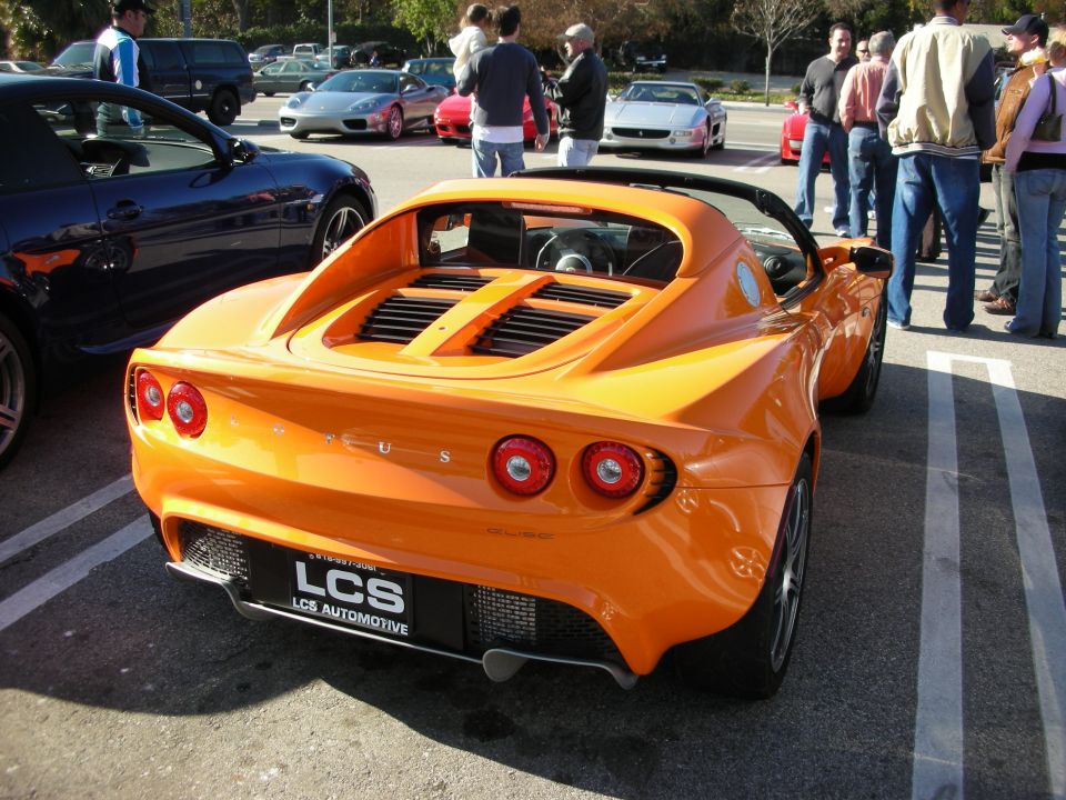 Orange Lotus Elise rear view with engine louvers and LCS Automotive plate