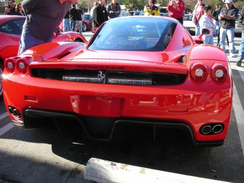 1998 Ford Crown Victoria - red Ferrari Enzo seen from directly behind, showing the four round taillights, mesh grille and dual exhaust outlets.