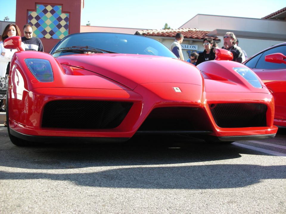 Front low-angle view of a red Ferrari Enzo at an outdoor car gathering