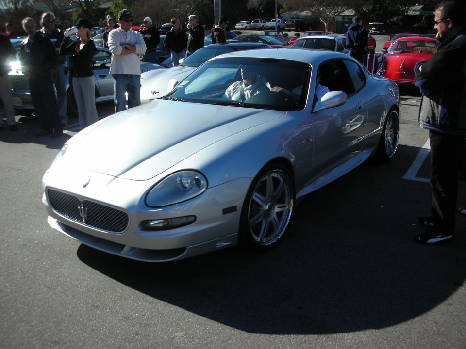 Silver Maserati coupe front three-quarter with chrome wheels at a car show