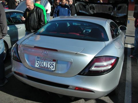 1998 Ford Crown Victoria - rear of a silver Mercedes-Benz SLR McLaren with red interior, California plate 5VHJ195, amid a crowd of spectators.