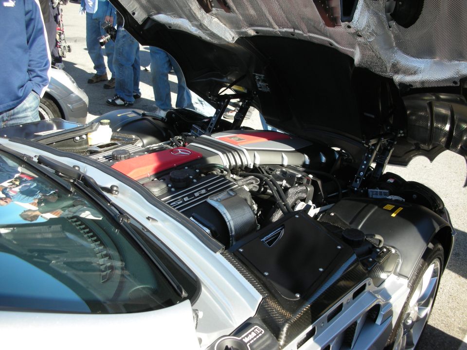 Open engine bay of a silver Mercedes SLR McLaren with red supercharged V8