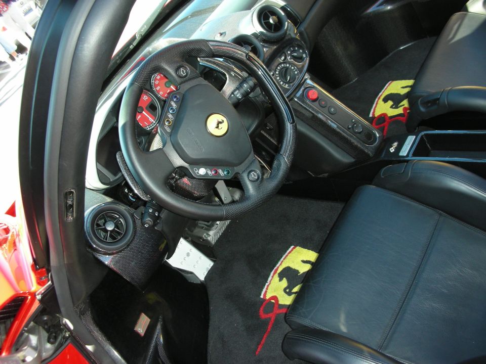 Ferrari cockpit with carbon trim and floor mats embroidered with prancing horses