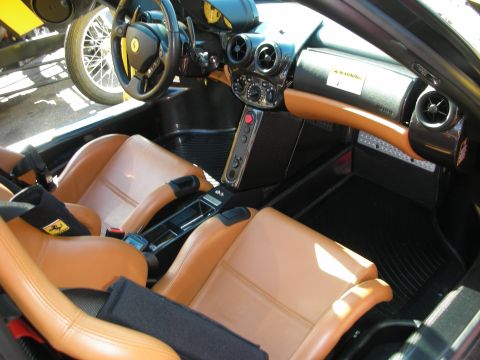 1998 Ford Crown Victoria - two-tone tan and black interior of a Ferrari Enzo, with leather bucket seats, carbon footwell, and a warning label on the dash.