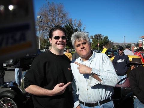1998 Ford Crown Victoria - Two men pose for a photo at a sunny outdoor car gathering, both pointing toward each other and smiling.