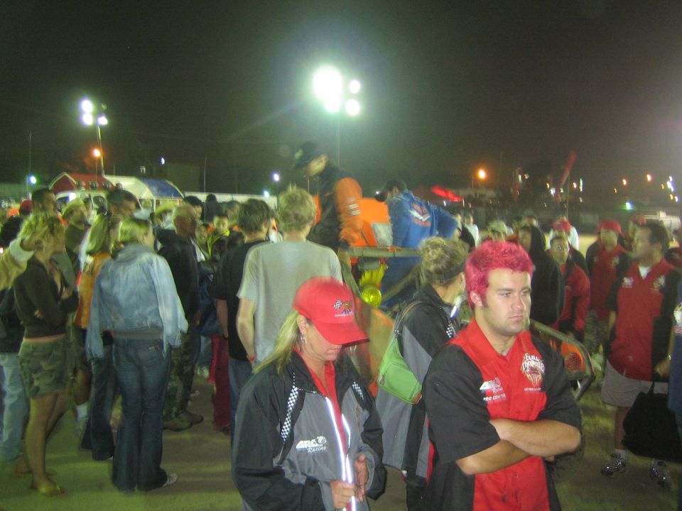 Nighttime crowd at an outdoor event under stadium lights