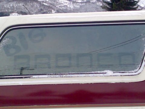 1989 Ford Bronco - Side view of a 1989 Ford Bronco with 'BIG BRONCO' visible on the frosted window.